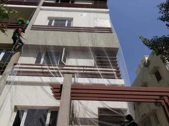 Professional safety net installation across a building opening