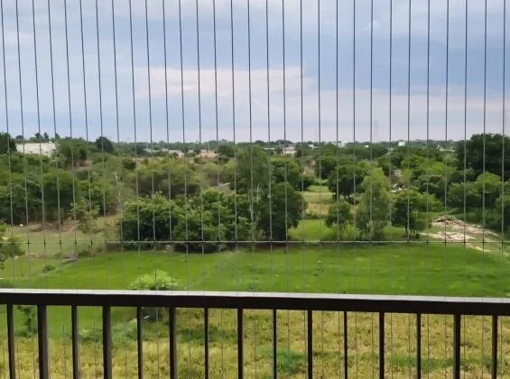 Invisible grill cables installed across an apartment balcony